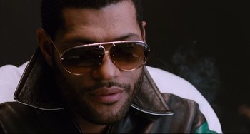 Movie still from “Deep Cover” (1992), directed by Bill Duke – A person wearing sunglasses and a leather jacket; Close Up shot, Low angle