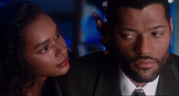 Movie still from “Deep Cover” (1992), directed by Bill Duke – A man and a woman in a suit and tie looking at each other; Close Up shot, Over the shoulder angle