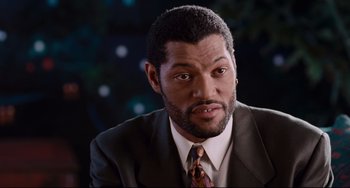 Movie still from “Deep Cover” (1992), directed by Bill Duke – A person wearing a suit and tie; Close Up shot, High angle