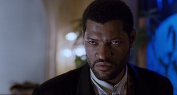 Movie still from “Deep Cover” (1992), directed by Bill Duke – A person wearing a suit and tie; Close Up shot, Low angle