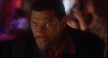 Movie still from “Deep Cover” (1992), directed by Bill Duke – A man with a serious look on his face; Close Up shot, Low angle