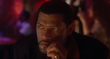 Movie still from “Deep Cover” (1992), directed by Bill Duke – A person holding a cigarette in his mouth; Close Up shot, Low angle