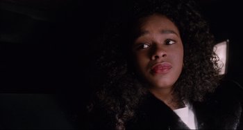 Movie still from “Deep Cover” (1992), directed by Bill Duke – A young girl with a black fur coat laying on the ground; Close Up shot, Low angle