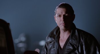 Movie still from “Deep Cover” (1992), directed by Bill Duke – A person wearing a leather jacket; Close Up shot, Low angle