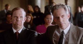 Movie still from “Deep Cover” (1992), directed by Bill Duke – Two men in suits and ties sitting in a room; Medium shot, Over the shoulder angle