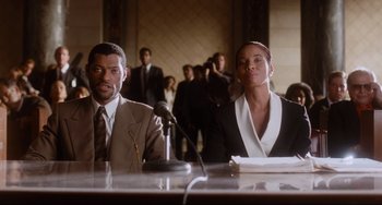 Movie still from “Deep Cover” (1992), directed by Bill Duke – A man and a woman sitting in front of microphones; Medium shot, Low angle