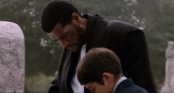 Movie still from “Deep Cover” (1992), directed by Bill Duke – A man and a boy in suits looking at each other; Close Up shot, Over the shoulder angle