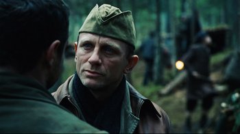 Movie still from “Defiance” (2008), directed by Edward Zwick – A person wearing a hat; Close Up shot, Over the shoulder angle