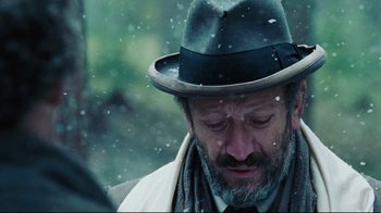 Movie still from “Defiance” (2008), directed by Edward Zwick – A person wearing a hat; Close Up shot, Over the shoulder angle