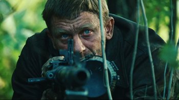 Movie still from “Defiance” (2008), directed by Edward Zwick – A person with a gun; Close Up shot, Over the shoulder angle