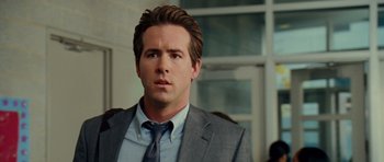 Movie still from “Definitely, Maybe” (2008), directed by Adam Brooks – A person wearing a suit and tie; Close Up shot, Over the shoulder angle