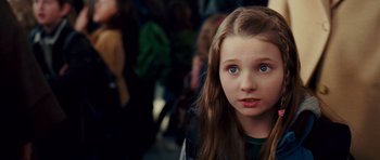 Movie still from “Definitely, Maybe” (2008), directed by Adam Brooks – A young girl with blue eyes stares into the camera; Close Up shot, Over the shoulder angle