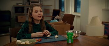 Movie still from “Definitely, Maybe” (2008), directed by Adam Brooks – A girl sitting at a table with food in front of her; Medium shot, Over the shoulder angle