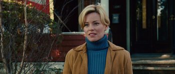 Movie still from “Definitely, Maybe” (2008), directed by Adam Brooks – A woman with short blonde hair wearing a blue sweater; Close Up shot, Over the shoulder angle