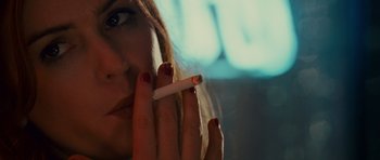 Movie still from “Definitely, Maybe” (2008), directed by Adam Brooks – A person holding a cigarette; Close Up shot, Over the shoulder angle
