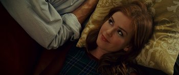 Movie still from “Definitely, Maybe” (2008), directed by Adam Brooks – A beautiful young lady laying on top of a couch; Close Up shot, Overhead angle