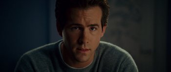 Movie still from “Definitely, Maybe” (2008), directed by Adam Brooks – A man's face in a dark room; Close Up shot, Over the shoulder angle