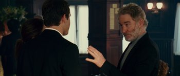 Movie still from “Definitely, Maybe” (2008), directed by Adam Brooks – Two men in business suits talking to each other; Close Up shot, Over the shoulder angle