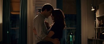 Movie still from “Definitely, Maybe” (2008), directed by Adam Brooks – A man and a woman embracing each other in the dark; Medium shot, Over the shoulder angle