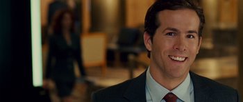Movie still from “Definitely, Maybe” (2008), directed by Adam Brooks – A person wearing a suit and tie; Close Up shot, Over the shoulder angle