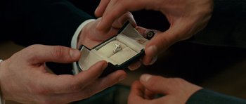 Movie still from “Definitely, Maybe” (2008), directed by Adam Brooks – A person is holding a ring in a box; Extreme Close Up shot, High angle