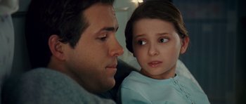 Movie still from “Definitely, Maybe” (2008), directed by Adam Brooks – A man and a little girl sitting next to each other; Close Up shot, Over the shoulder angle
