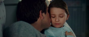 Movie still from “Definitely, Maybe” (2008), directed by Adam Brooks – A man and a little girl kissing each other; Close Up shot, Over the shoulder angle