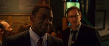 Movie still from “Definitely, Maybe” (2008), directed by Adam Brooks – A man in a suit and tie standing next to another man; Close Up shot, Over the shoulder angle