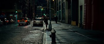 Movie still from “Definitely, Maybe” (2008), directed by Adam Brooks – A woman walking down a street at night; Extreme Wide shot, High angle