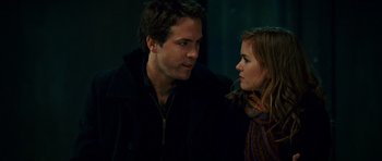 Movie still from “Definitely, Maybe” (2008), directed by Adam Brooks – A man and a woman standing next to each other; Close Up shot, Over the shoulder angle