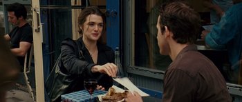 Movie still from “Definitely, Maybe” (2008), directed by Adam Brooks – A woman sitting at a table with a man; Medium shot, Over the shoulder angle