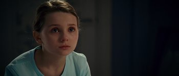 Movie still from “Definitely, Maybe” (2008), directed by Adam Brooks – A young girl is sitting in the dark looking sad; Close Up shot, High angle