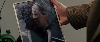 Movie still from “Definitely, Maybe” (2008), directed by Adam Brooks – A person holding a picture of a man; Extreme Close Up shot, High angle