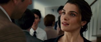 Movie still from “Definitely, Maybe” (2008), directed by Adam Brooks – A woman in a crowd of people; Close Up shot, Over the shoulder angle