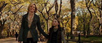 Movie still from “Definitely, Maybe” (2008), directed by Adam Brooks – A woman and a young girl holding hands in a park; Medium shot, Over the shoulder angle