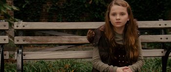 Movie still from “Definitely, Maybe” (2008), directed by Adam Brooks – A young girl sitting on a park bench; Medium shot, Over the shoulder angle