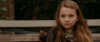 Movie still from “Definitely, Maybe” (2008), directed by Adam Brooks – A girl sitting on top of a wooden park bench; Close Up shot, Over the shoulder angle