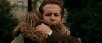 Movie still from “Definitely, Maybe” (2008), directed by Adam Brooks – A man and a woman hug in the rain; Close Up shot, Over the shoulder angle