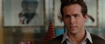 Movie still from “Definitely, Maybe” (2008), directed by Adam Brooks – A person wearing a suit and tie; Close Up shot, Over the shoulder angle