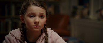 Movie still from “Definitely, Maybe” (2008), directed by Adam Brooks – A young girl with braids looking at the camera; Close Up shot, High angle