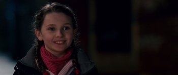 Movie still from “Definitely, Maybe” (2008), directed by Adam Brooks – A young girl smiling for the camera in the dark; Close Up shot, Over the shoulder angle