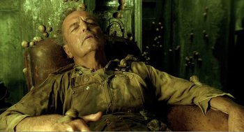 Movie still from “Delicatessen” (1991), directed by Marc Caro – An old man is sleeping on a couch; Close Up shot, High angle
