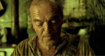 Movie still from “Delicatessen” (1991), directed by Marc Caro – An old man with a beard and a mustache; Close Up shot, Low angle