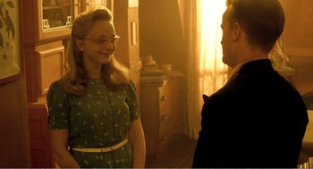 Movie still from “Delicatessen” (1991), directed by Marc Caro – A man and a woman are talking in a room; Medium shot, Over the shoulder angle