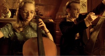 Movie still from “Delicatessen” (1991), directed by Marc Caro – A man and a woman are playing the cello; Medium shot, Low angle
