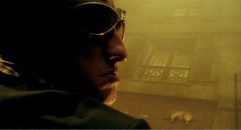 Movie still from “Delicatessen” (1991), directed by Marc Caro – A person wearing sunglasses; Extreme Close Up shot, Low angle