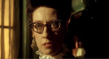 Movie still from “Delicatessen” (1991), directed by Marc Caro – A person wearing glasses; Close Up shot, Low angle