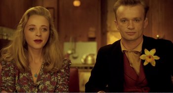 Movie still from “Delicatessen” (1991), directed by Marc Caro – A man and a woman sitting next to each other in a kitchen; Close Up shot, Low angle