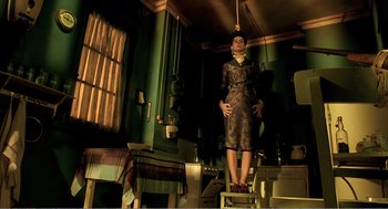 Movie still from “Delicatessen” (1991), directed by Marc Caro – A woman standing on top of a ladder in a room; Wide shot, Low angle