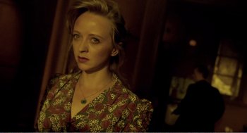 Movie still from “Delicatessen” (1991), directed by Marc Caro – A woman with blonde hair wearing a floral dress; Close Up shot, Over the shoulder angle